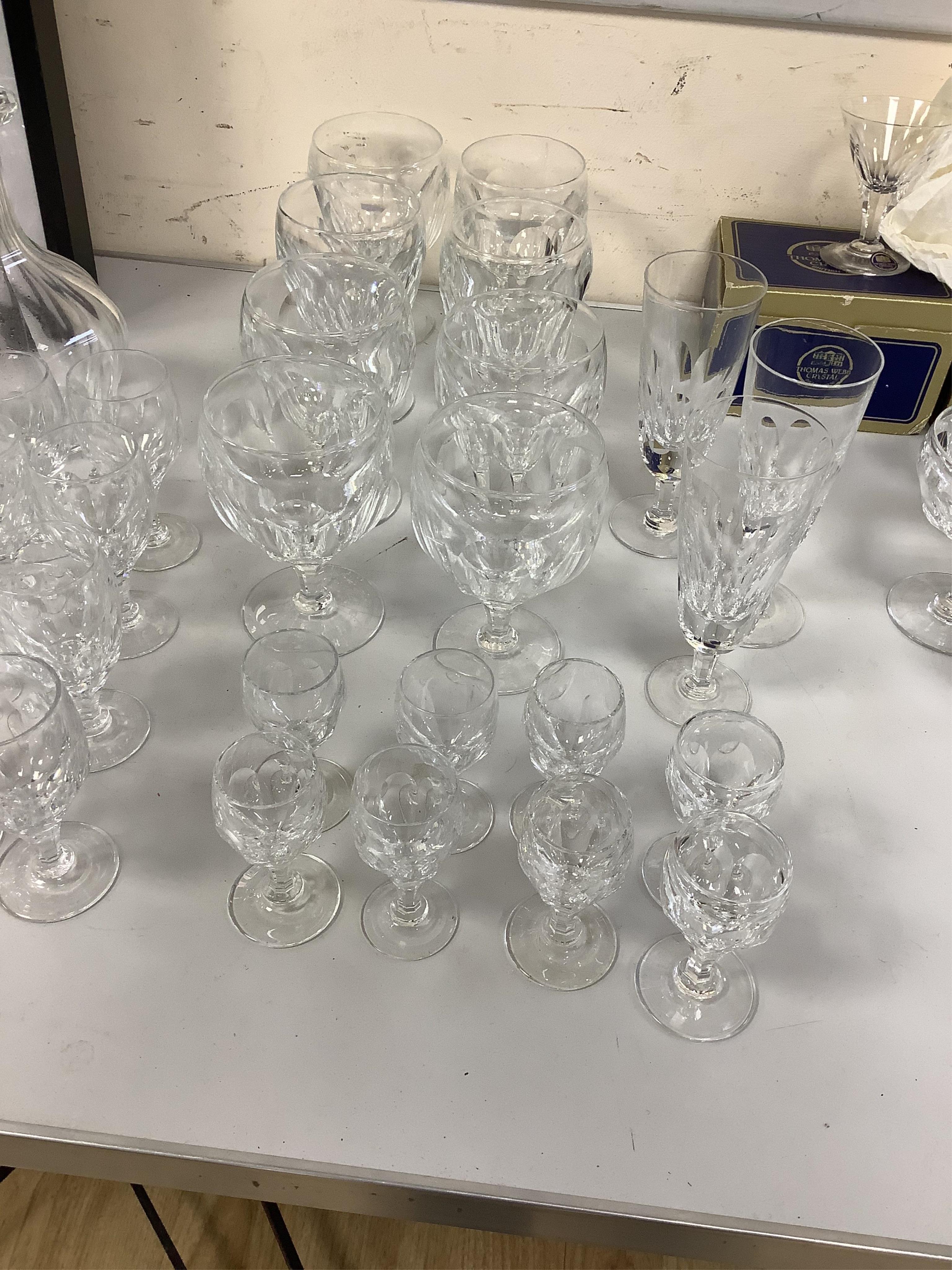 A suite of Thomas Webb Crystal wine glasses, Royal Yacht pattern, including two decanters, eight goblets, white wines and clarets, sixty-four pieces. Condition - mostly good